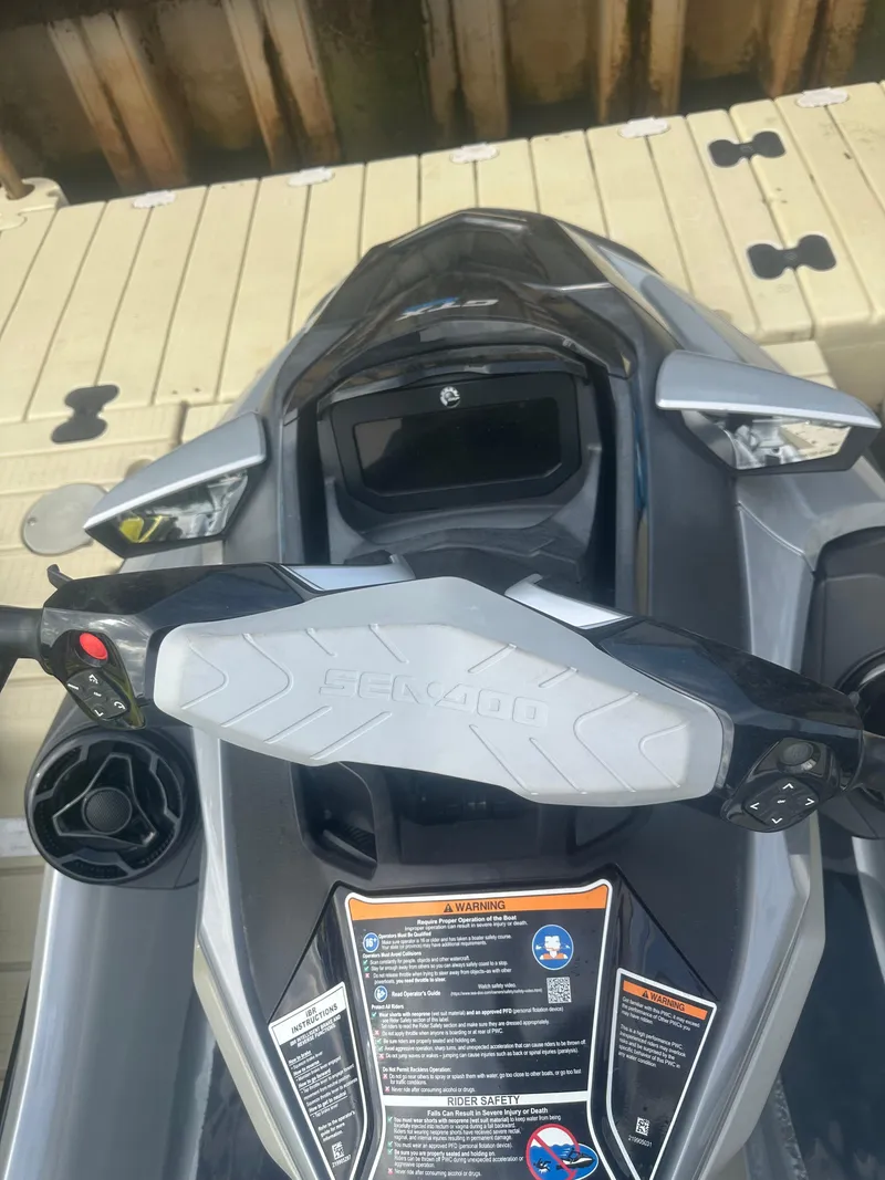 Slide: The Image of 2021 Sea-Doo GTX Limited 300 jet ski dashboard and controls on a dock. - 6