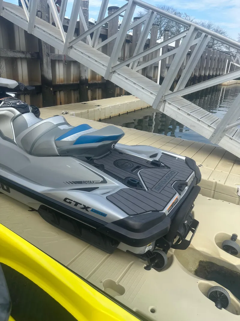 Slide: The Image of 2021 Sea-Doo GTX Limited 300 jet ski docked by a wooden pier. - 7