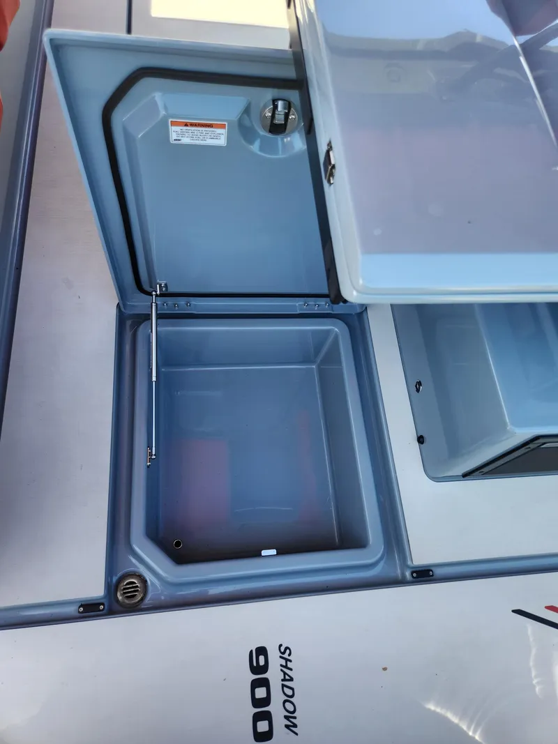 Slide: The Image of 2022 Axopar Brabus Shadow 900 ST storage compartment with open lid. - 12