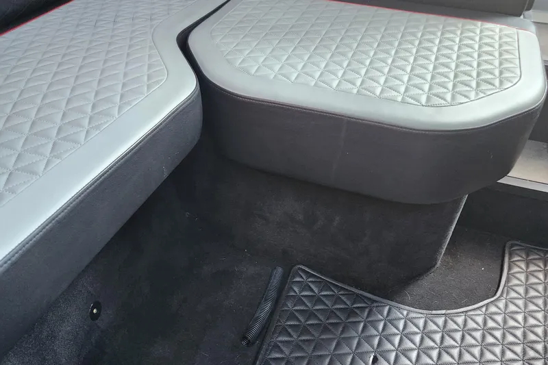 Slide: The Image of Quilted seating and floor mat in 2022 Axopar Brabus Shadow 900 ST boat interior. - 16