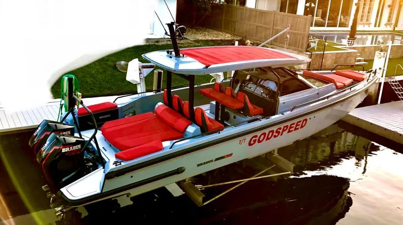 Slide: The Image of 2022 Axopar Brabus Shadow 900 ST boat with red seating, docked in a marina. - 21