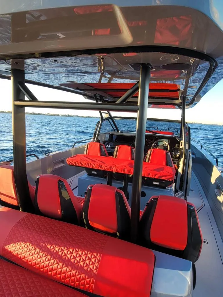 Slide: The Image of 2022 Axopar Brabus Shadow 900 ST with vibrant red seating on open water. - 4