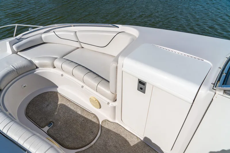 Slide: The Image of 2002 Ebbtide 2400 Mystique Fun Cruiser interior with cushioned seating and storage. - 13