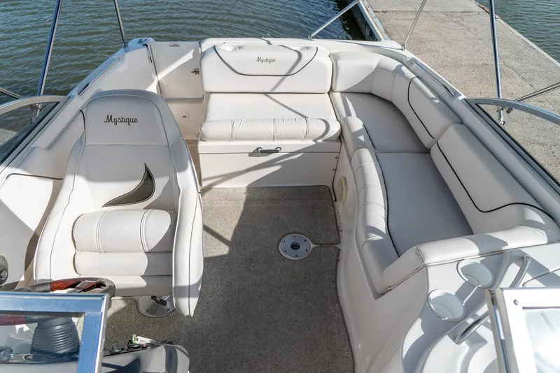 Slide: The Image of 2002 Ebbtide 2400 Mystique Fun Cruiser interior with white seating and spacious layout. - 16