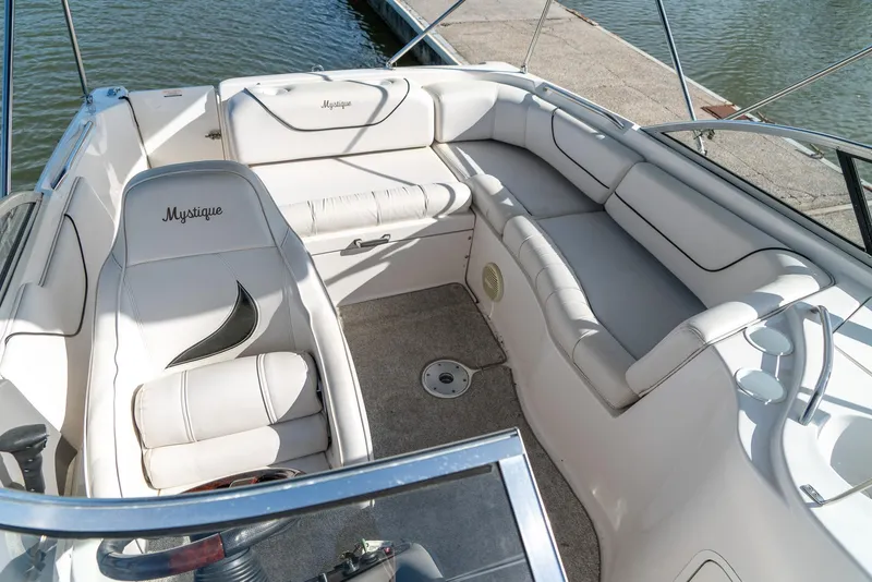 Slide: The Image of 2002 Ebbtide 2400 Mystique Fun Cruiser boat interior with white seating and open deck. - 17