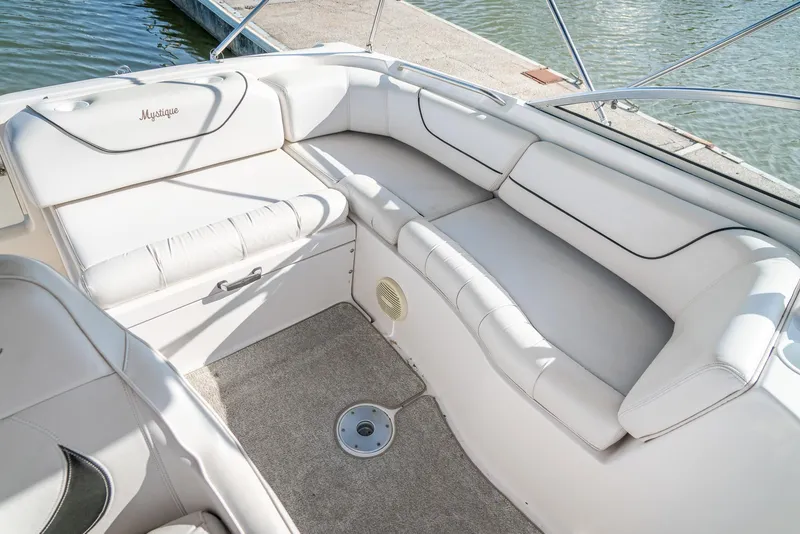Slide: The Image of 2002 Ebbtide 2400 Mystique Fun Cruiser interior with white seating and carpeted floor. - 18