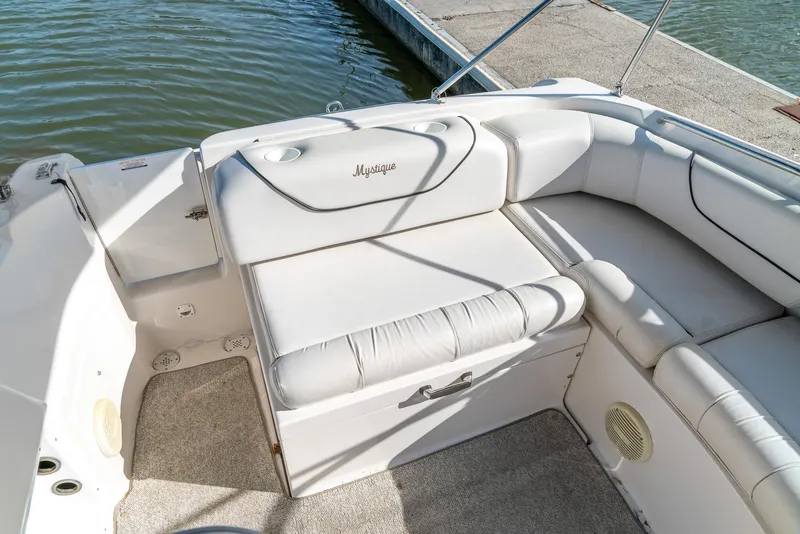 Slide: The Image of 2002 Ebbtide 2400 Mystique Fun Cruiser boat interior with white seating near dock. - 19