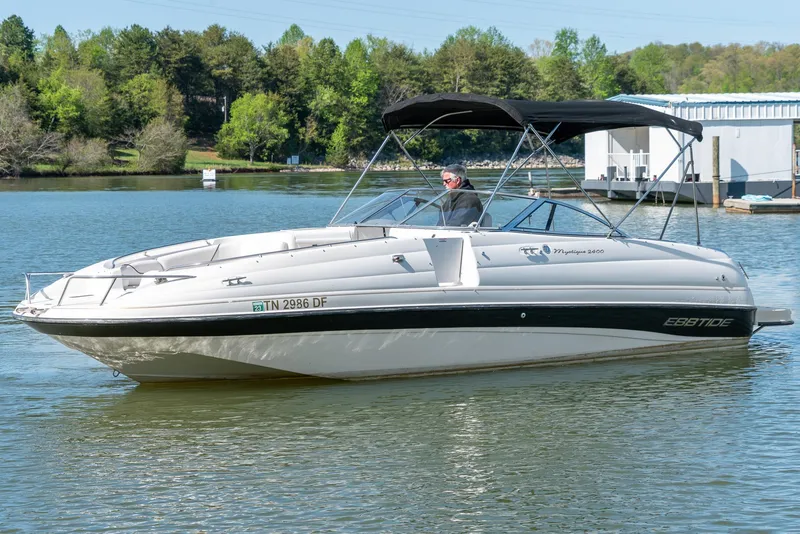 Slide: The Image of 2002 Ebbtide 2400 Mystique Fun Cruiser on a serene lake. - 3