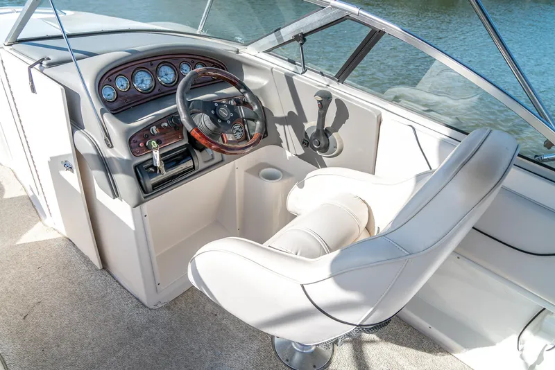 Slide: The Image of 2002 Ebbtide 2400 Mystique Fun Cruiser cockpit with steering wheel and gauges. - 8