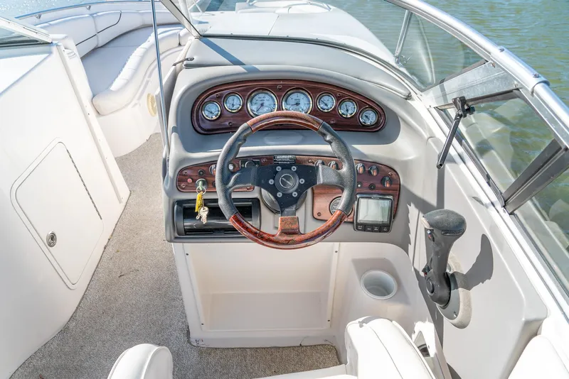 Slide: The Image of 2002 Ebbtide 2400 Mystique Fun Cruiser dashboard with steering wheel and gauges. - 9