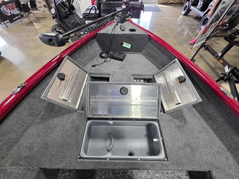Slide: The Image of 2025 Tracker Super Guide V 16 T boat interior with storage compartments open. - 14