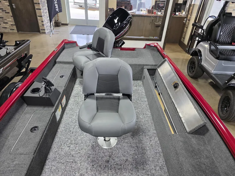 Slide: The Image of 2025 Tracker Super Guide V 16 T boat interior with gray seating and storage compartments. - 15