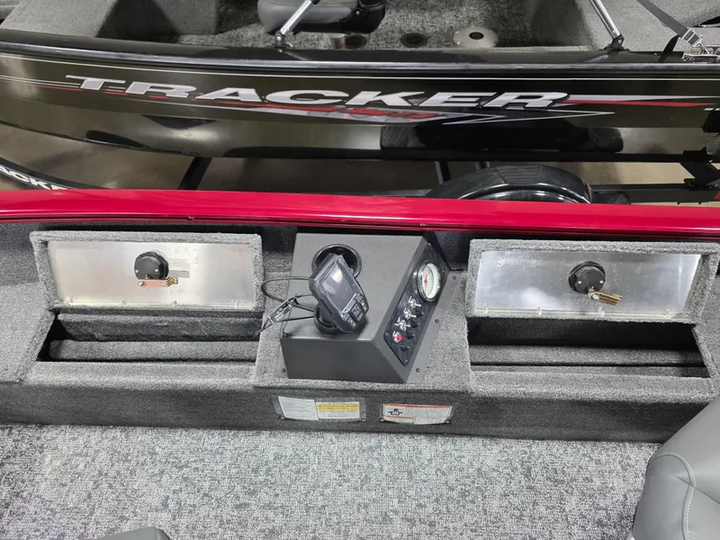 Slide: The Image of 2025 Tracker Super Guide V 16 T boat dashboard with controls and storage compartments. - 16