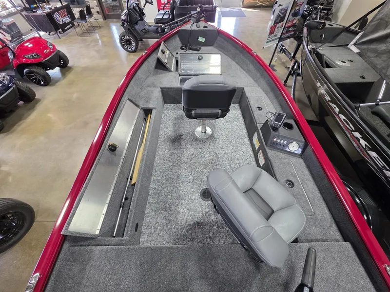 Slide: The Image of 2025 Tracker Super Guide V 16 T boat interior with gray seating and storage compartments. - 6