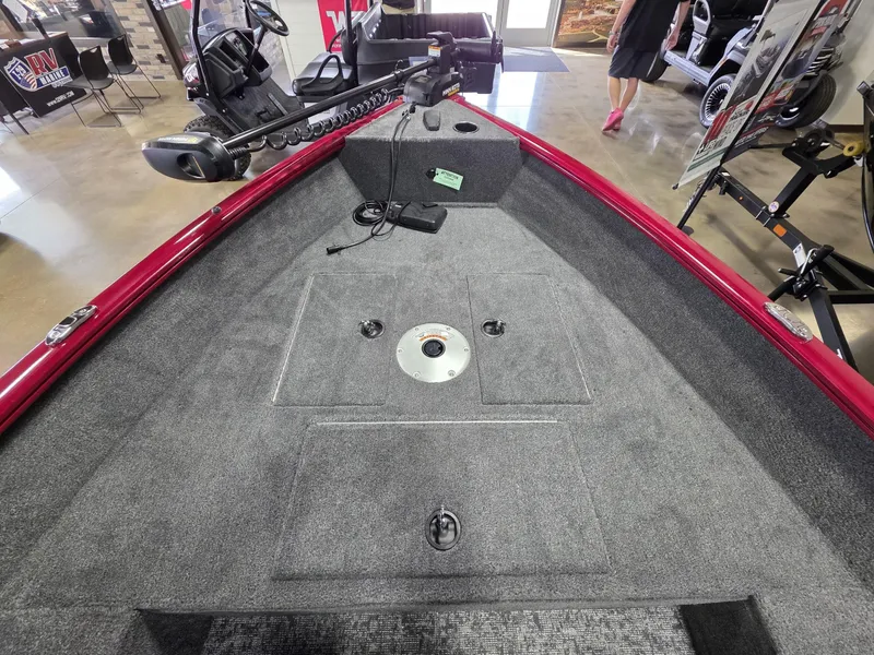 Slide: The Image of 2025 Tracker Super Guide V 16 T boat interior with carpeted deck and trolling motor. - 8