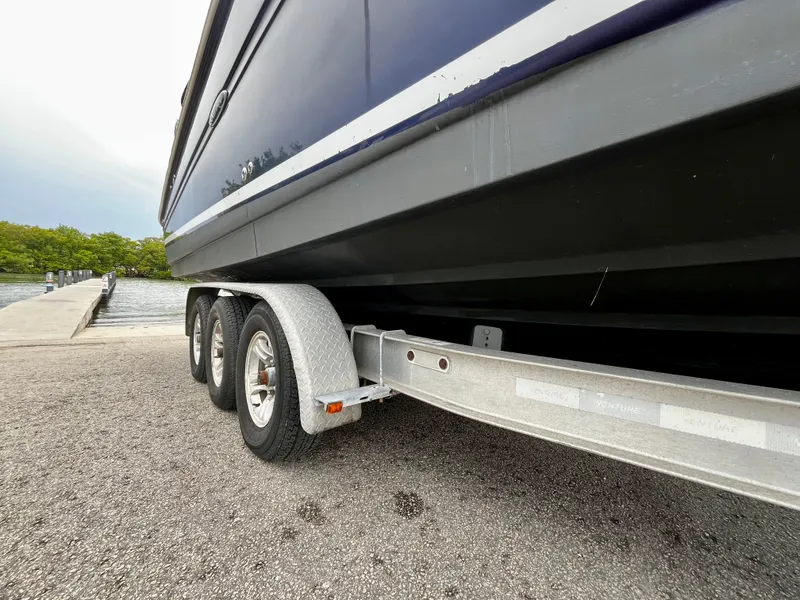 Slide: The Image of 2005 Sea Ray 280 Sundancer on trailer near a dock, side view. - 11