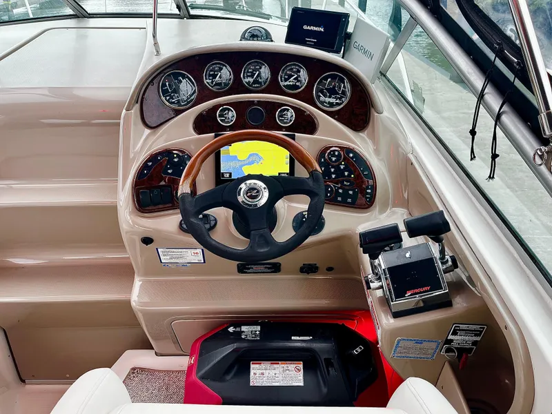 Slide: The Image of 2005 Sea Ray 280 Sundancer helm with Garmin navigation and Mercury controls. - 31