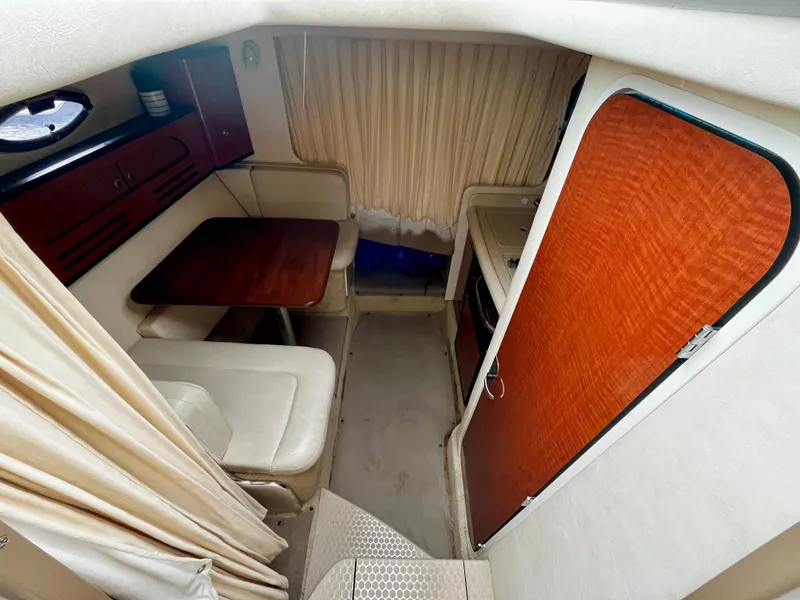 Slide: The Image of 2005 Sea Ray 280 Sundancer cabin interior with dining area and kitchenette. - 35