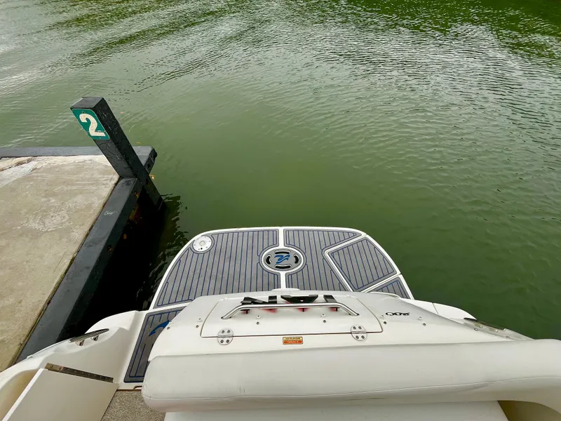 Slide: The Image of 2005 Sea Ray 280 Sundancer swim platform at dock, calm green water. - 42