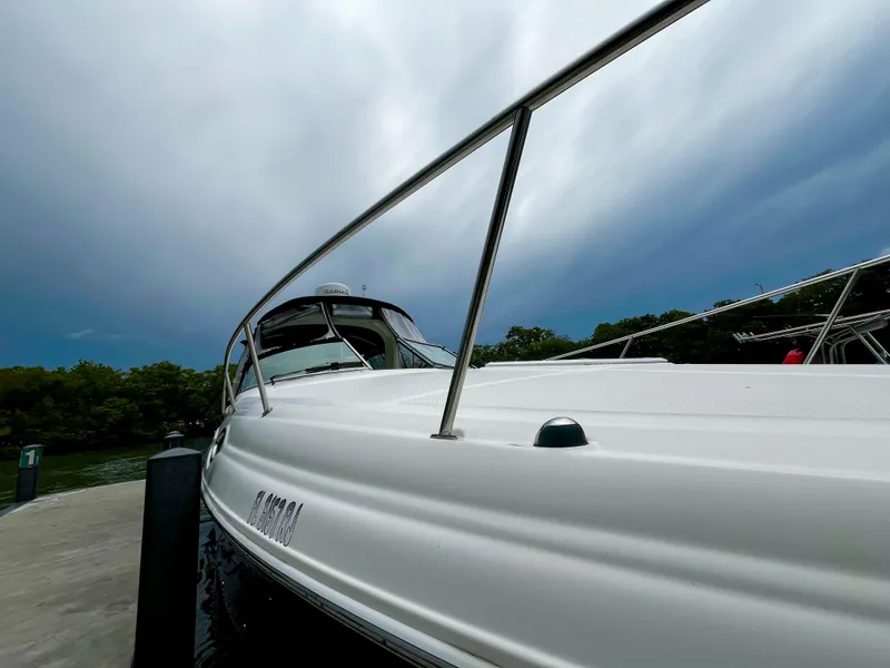 Slide: The Image of 2005 Sea Ray 280 Sundancer docked under cloudy sky. - 6