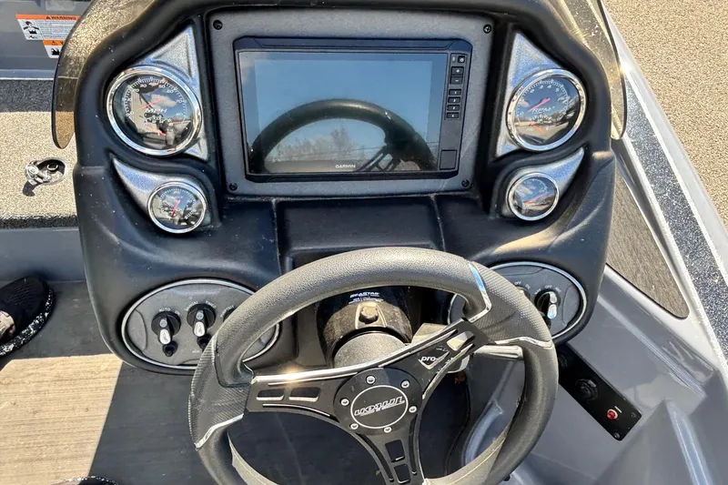 Slide: The Image of Dashboard of 2024 Triton 19 TrX boat with steering wheel and gauges. - 11