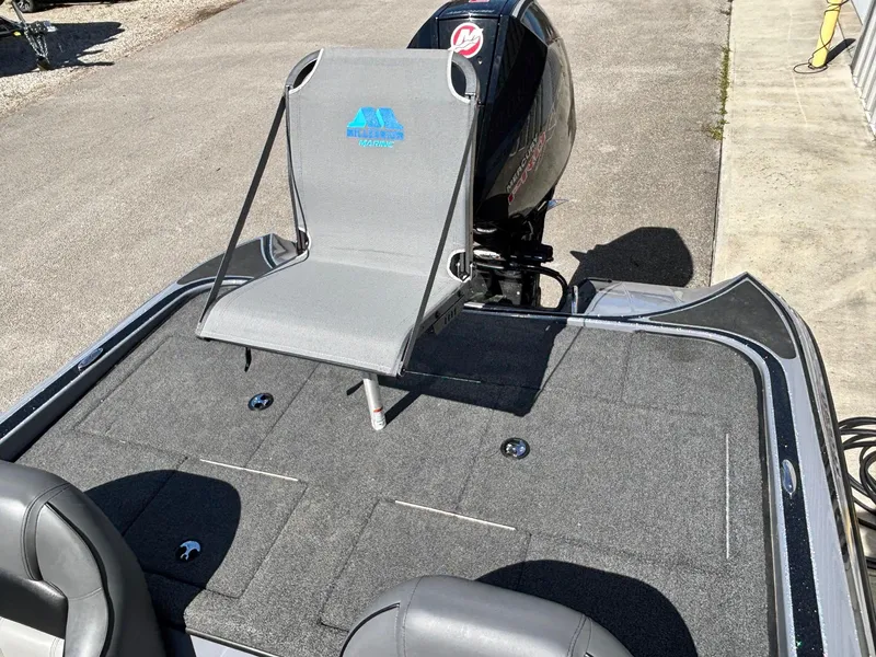 Slide: The Image of 2024 Triton 19 TrX boat with a gray fishing seat and powerful outboard motor. - 13