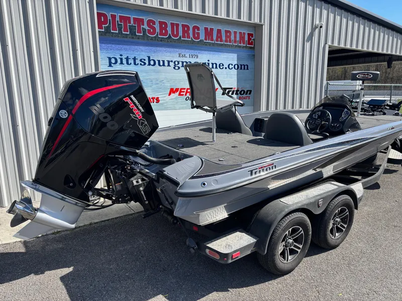 Slide: The Image of 2024 Triton 19 TrX boat at Pittsburg Marine dealership, featuring a powerful outboard motor. - 15