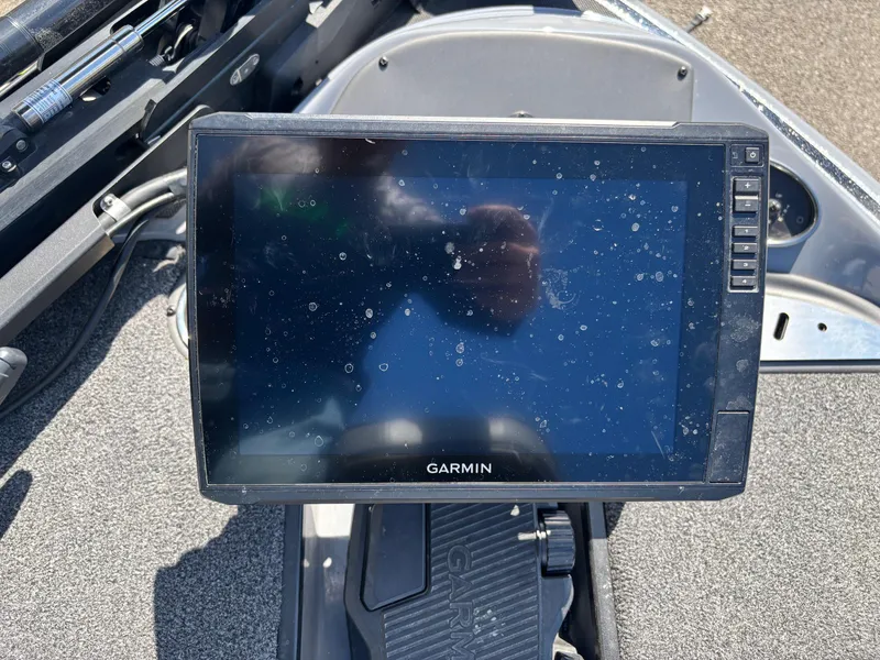 Slide: The Image of Garmin display on 2024 Triton 19 TrX boat dashboard, showing reflections and dust. - 4