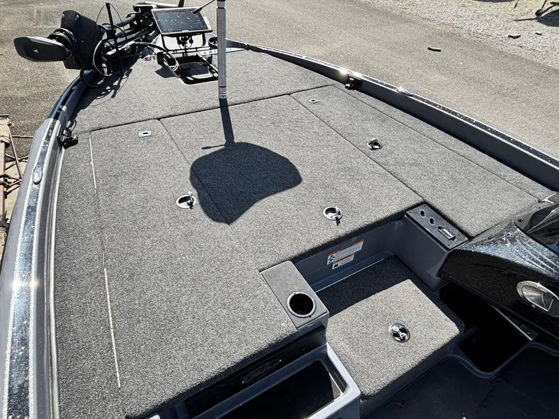 Slide: The Image of 2024 Triton 19 TrX boat deck with carpeted surface and mounted equipment. - 6