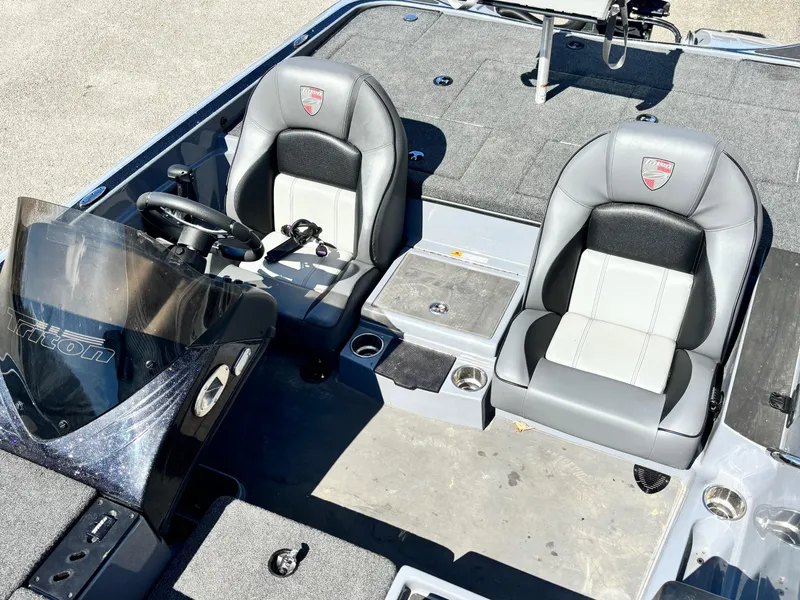 Slide: The Image of 2024 Triton 19 TrX boat interior with dual seats and steering console. - 8