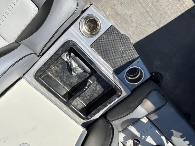 Slide: The Image of Interior of 2024 Triton 19 TrX boat showing cup holders and storage compartments. - 9