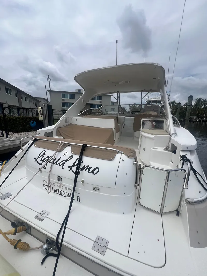 Slide: The Image of 2003 Regal Commodore 4260 yacht docked, featuring spacious deck and seating, Fort Lauderdale, FL. - 14