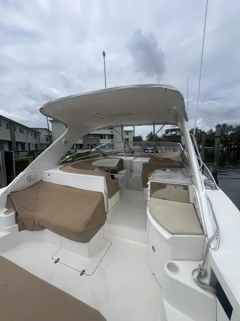 Slide: The Image of 2003 Regal Commodore 4260 yacht with spacious deck and covered seating area. - 16