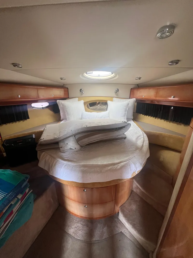 Slide: The Image of 2003 Regal Commodore 4260 cabin interior with bed and porthole. - 18