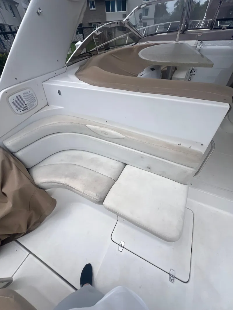 Slide: The Image of 2003 Regal Commodore 4260 yacht interior with white seating and beige accents. - 29