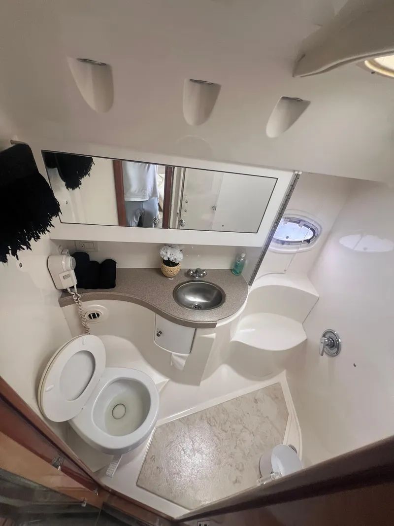 Slide: The Image of 2003 Regal Commodore 4260 bathroom with sink, toilet, and shower. - 36