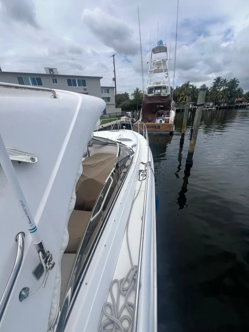 Slide: The Image of 2003 Regal Commodore 4260 yacht docked at marina, cloudy sky, waterfront view. - 37