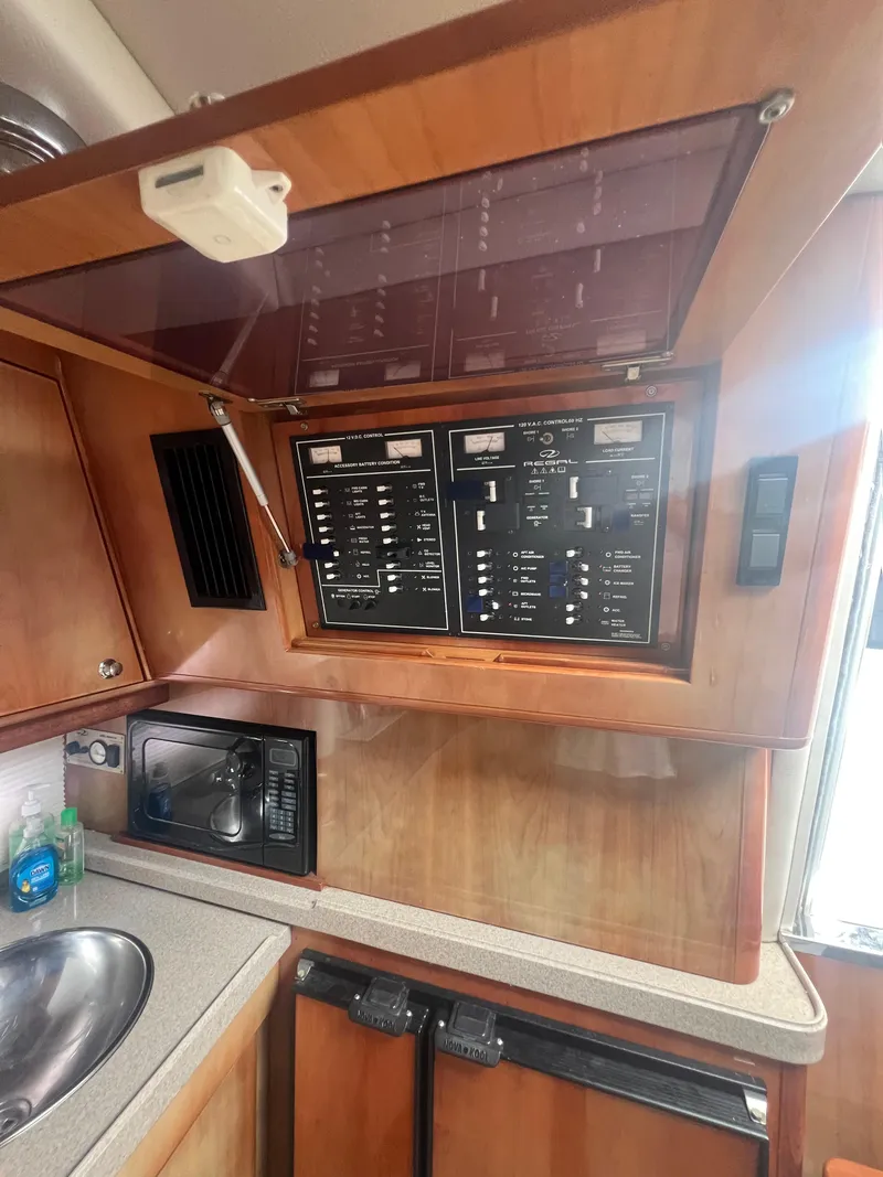 Slide: The Image of 2003 Regal Commodore 4260 yacht interior with control panel and kitchenette. - 39
