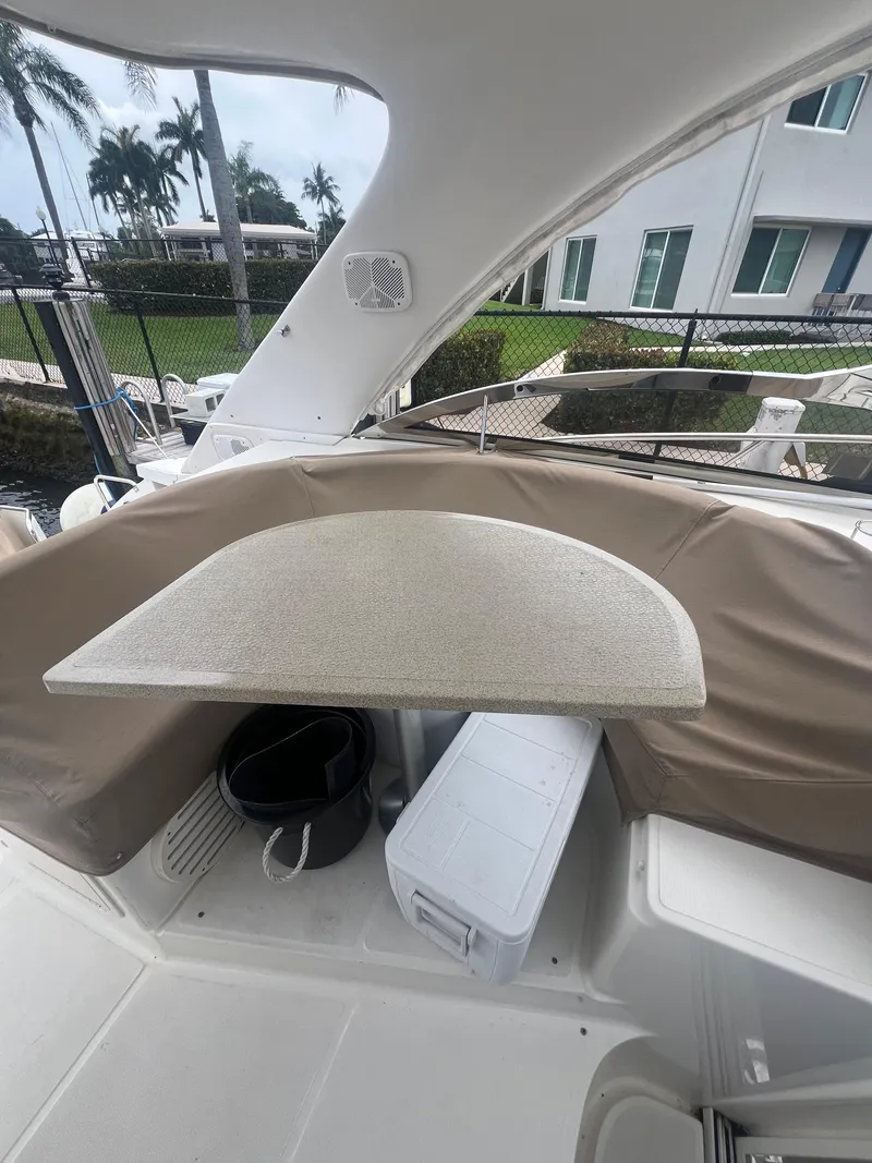 Slide: The Image of 2003 Regal Commodore 4260 boat interior with table and seating area. - 40