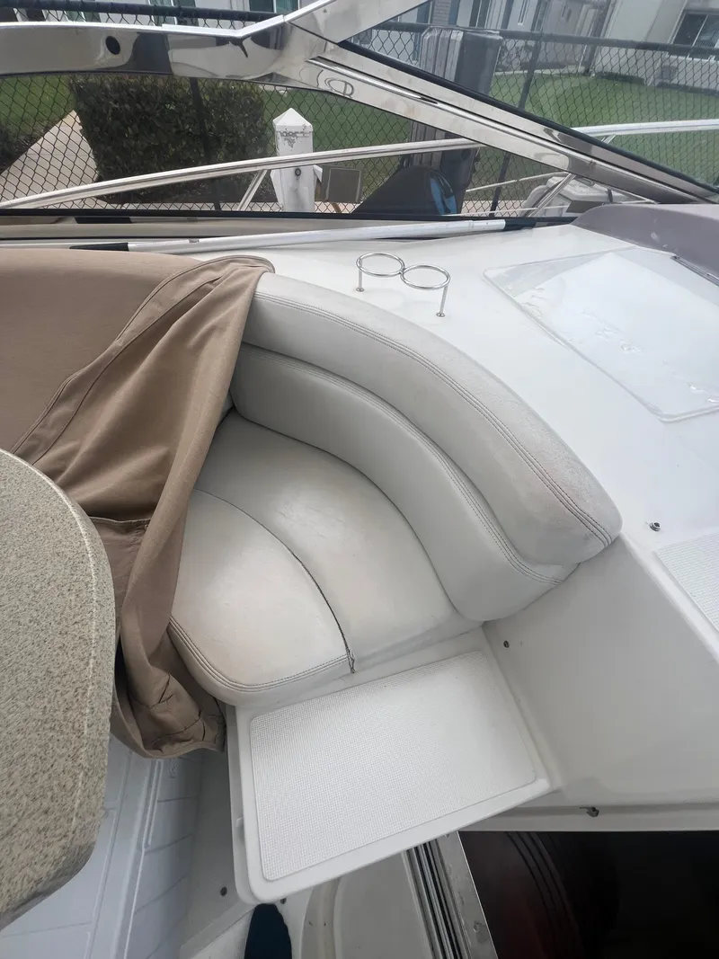 Slide: The Image of 2003 Regal Commodore 4260 boat with white leather seating and beige cover. - 42