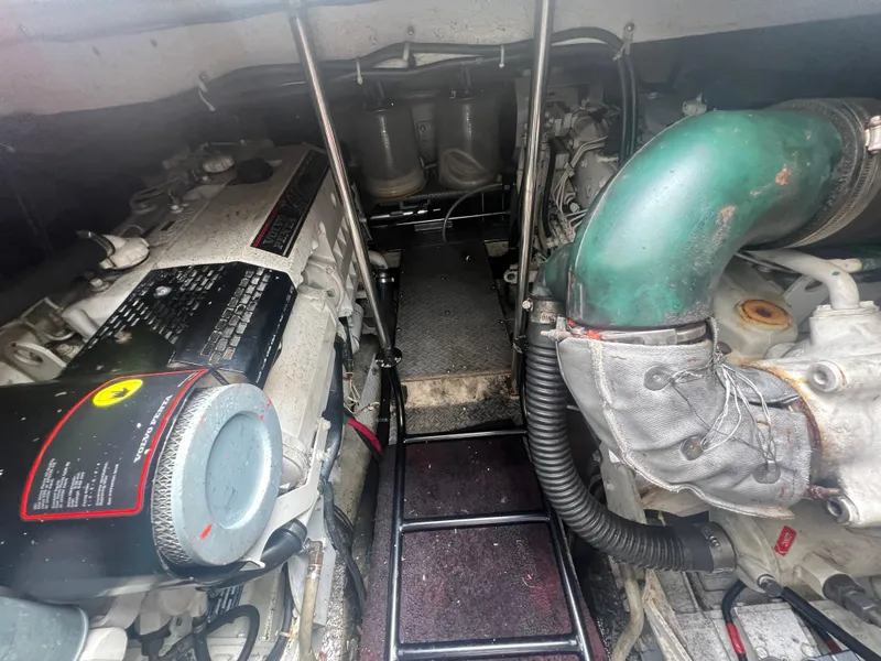 Slide: The Image of Engine room of a 2003 Regal Commodore 4260 boat, showcasing dual engines and mechanical components. - 51