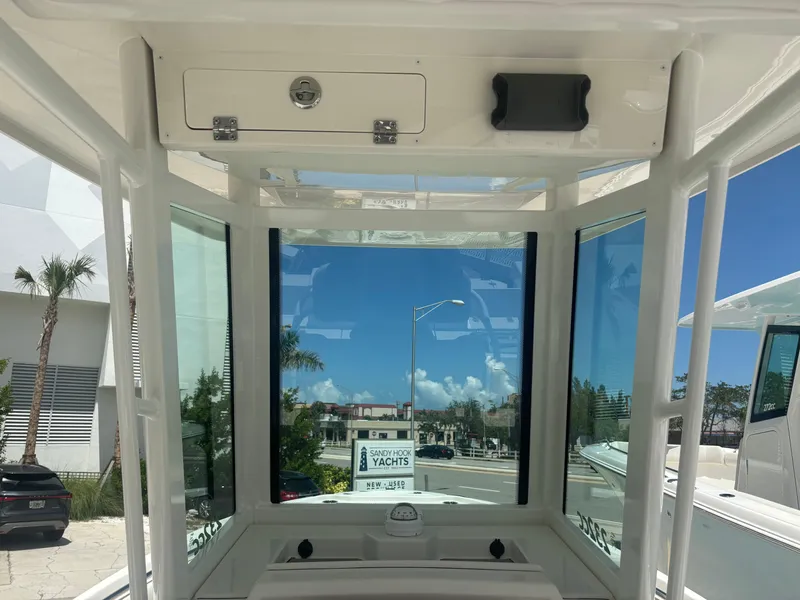 Slide: The Image of Interior view of 2026 Sailfish 232 CC boat with clear windows and storage compartment. - 12