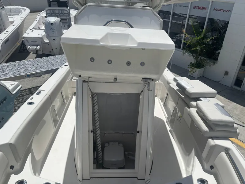 Slide: The Image of 2026 Sailfish 232 CC boat interior with open storage compartment and seating. - 14