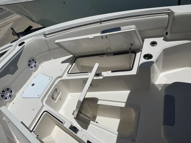 Slide: The Image of 2026 Sailfish 232 CC boat interior with open storage compartments and cup holders. - 16