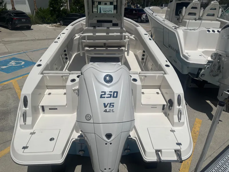 Slide: The Image of 2026 Sailfish 232 CC boat with powerful 250 V6 engine, displayed at a yacht dealership. - 3