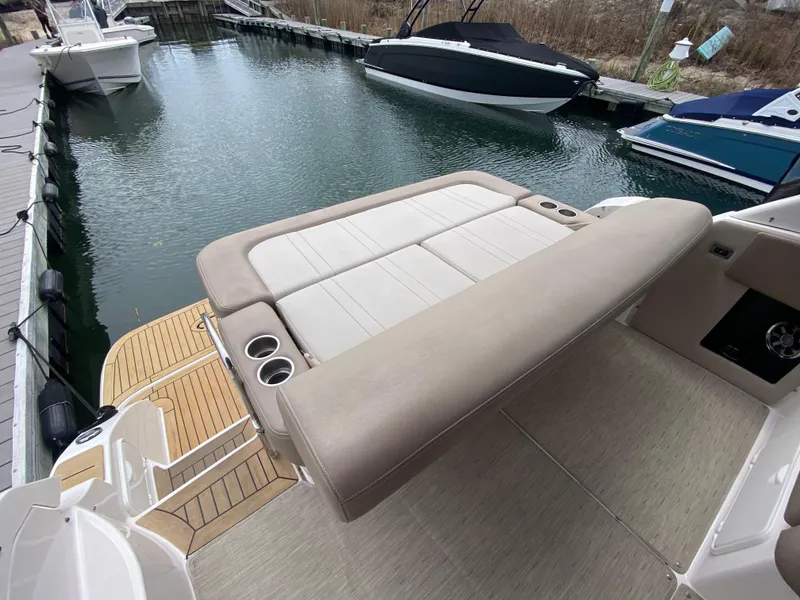 Slide: The Image of 2015 Regal 32 Express boat with spacious seating at a marina dock. - 12
