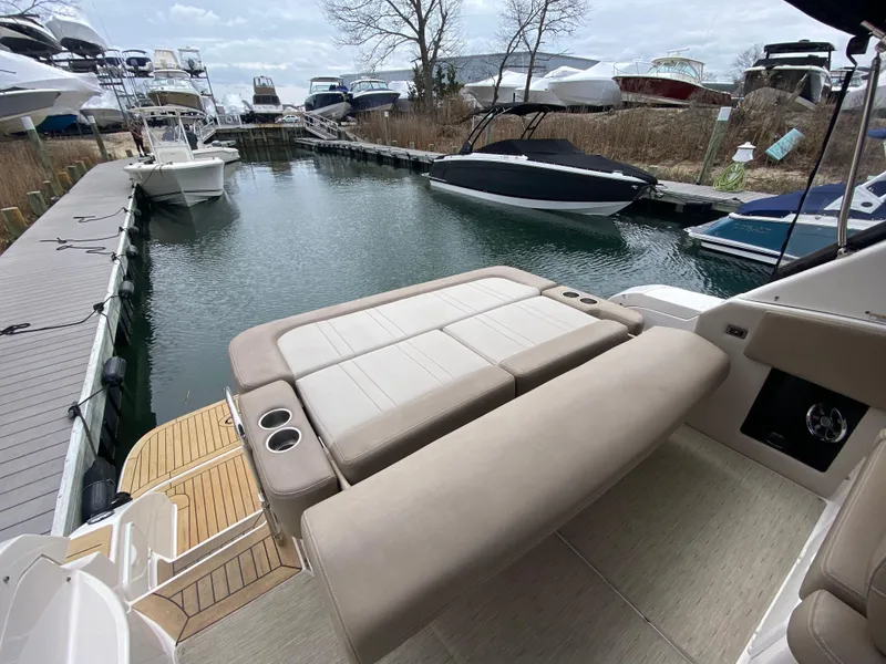 Slide: The Image of 2015 Regal 32 Express boat with spacious seating at a marina dock. - 13