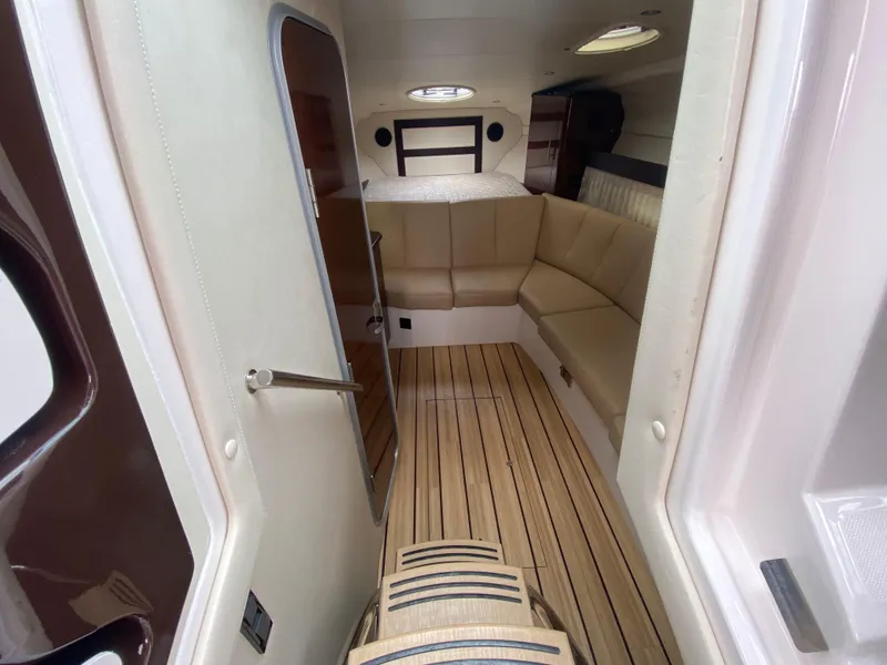 Slide: The Image of Interior of 2015 Regal 32 Express boat with seating and wood flooring. - 20
