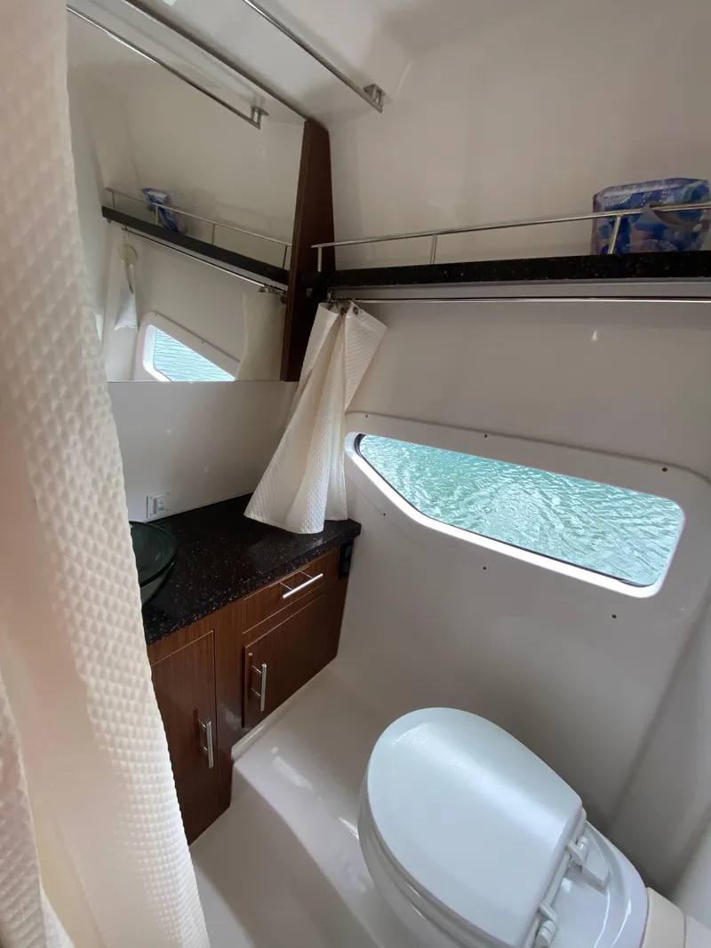 Slide: The Image of 2015 Regal 32 Express bathroom with modern fixtures and window view. - 22