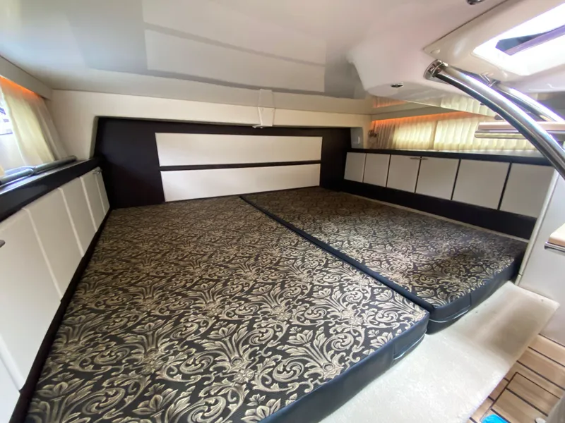 Slide: The Image of 2015 Regal 32 Express cabin interior with patterned bedding and modern design. - 28